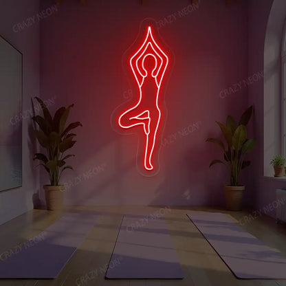 Vrikshasana Yoga Neon Sign lighting up in red color in a yoga room