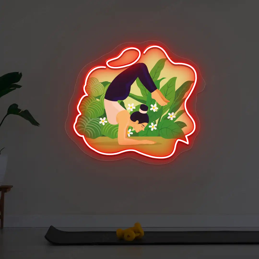Vrischikasana Garden Yoga Neon Artwork lighting up in red color in a yoga room