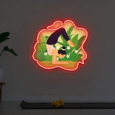 Vrischikasana Garden Yoga Neon Artwork lighting up in red color in a yoga room