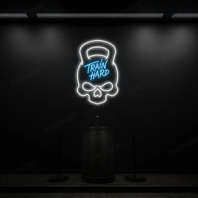ice blue and white train hard kettlebell neon sign mounted on a wall