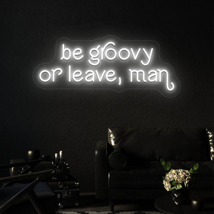 white be groovy or leave, man vintage neon sign mounted on a wall
