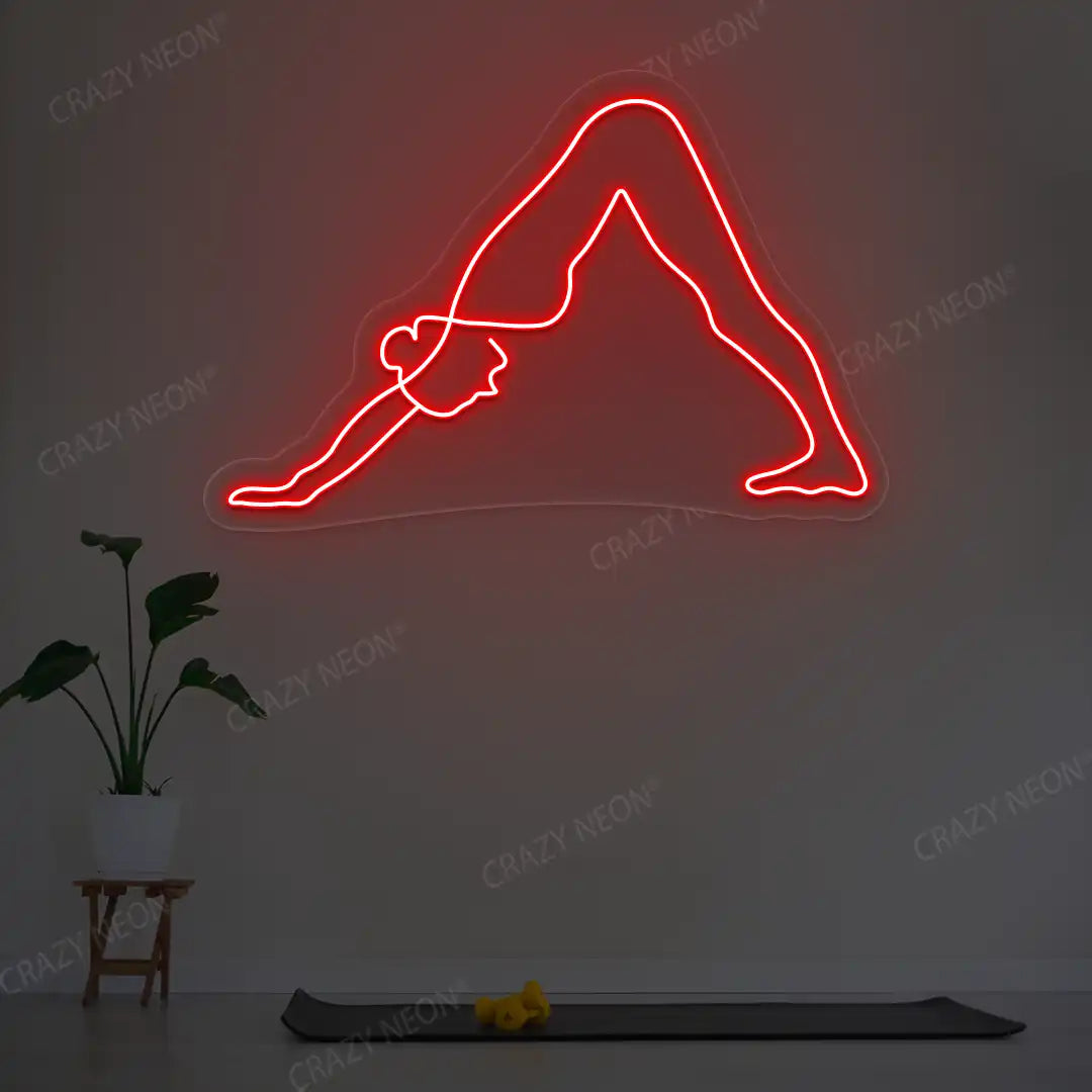 Adho Mukha Svanasana Yoga Neon Sign lighting up in red color in a yoga room