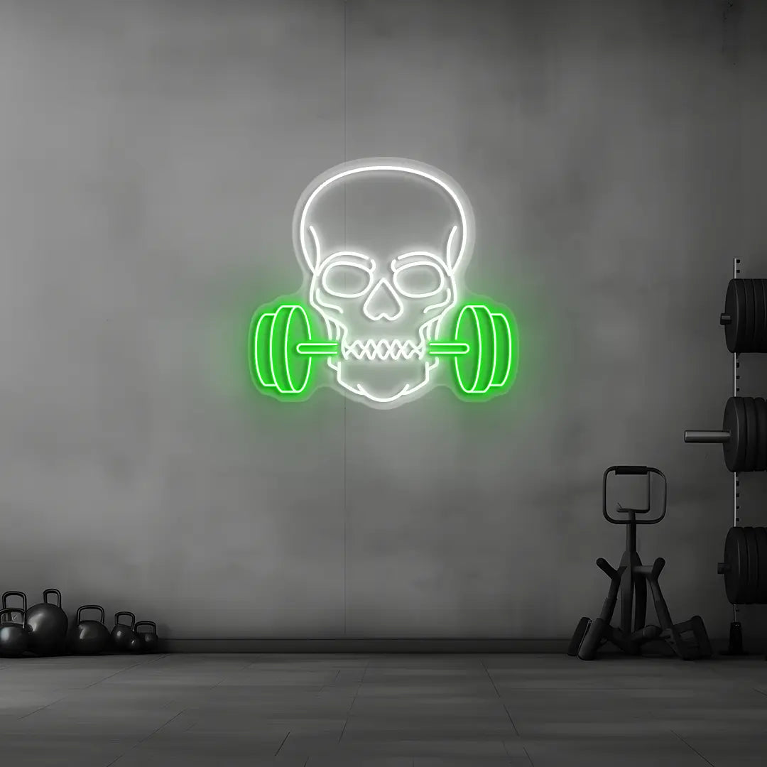 green and white skull barbell gym neon sign mounted on a wall