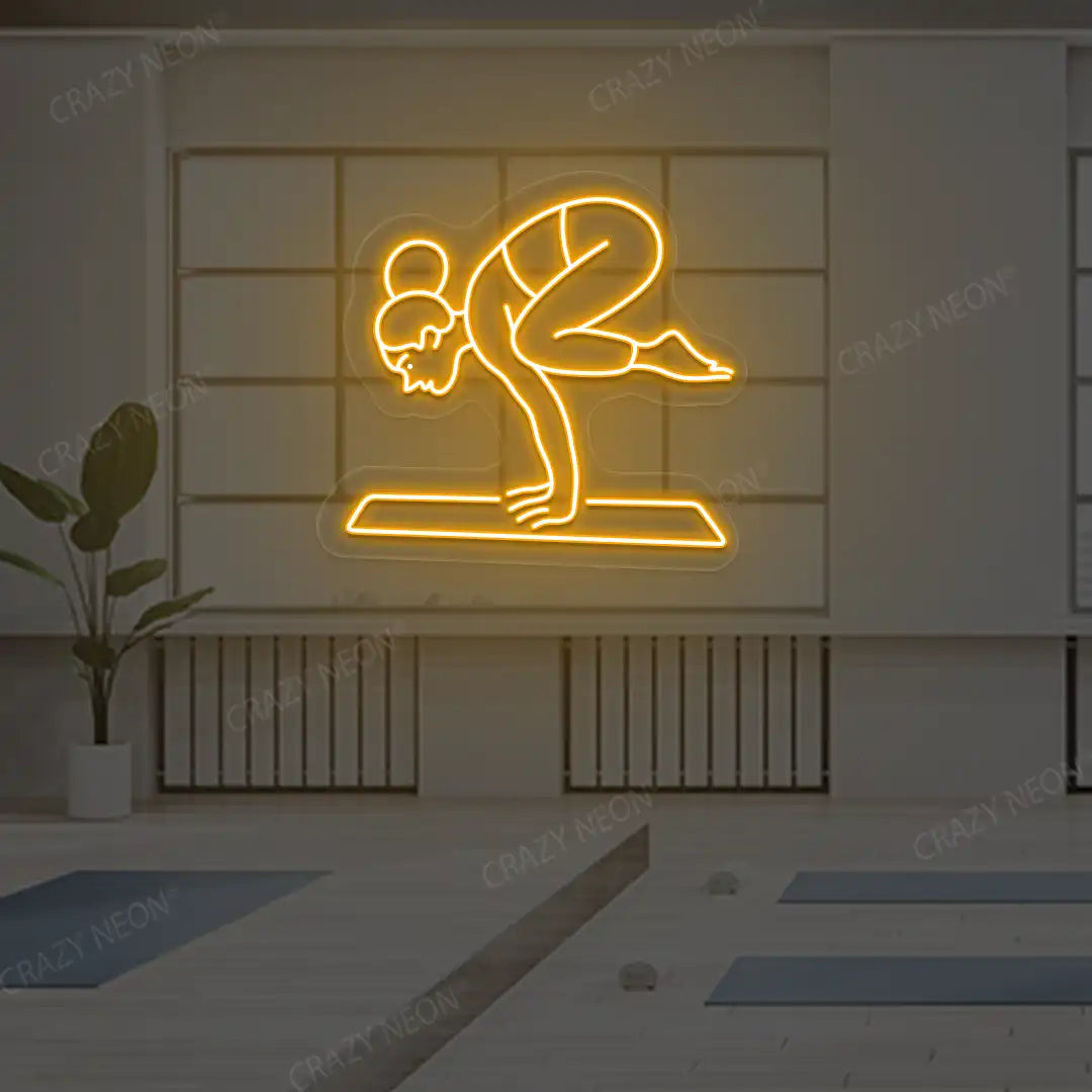 Bakasana Yoga Neon Sign lighting up in orange color in a yoga room