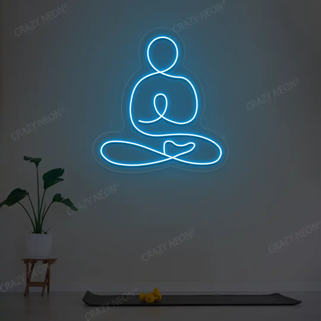 Swastikasana Yoga Neon Sign lighting up in ice blue color in a yoga room