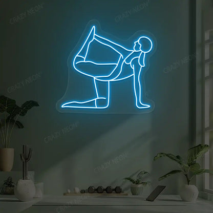 Ardha Dhanurasana Yoga Neon Sign glowing in ice blue color in a yoga room