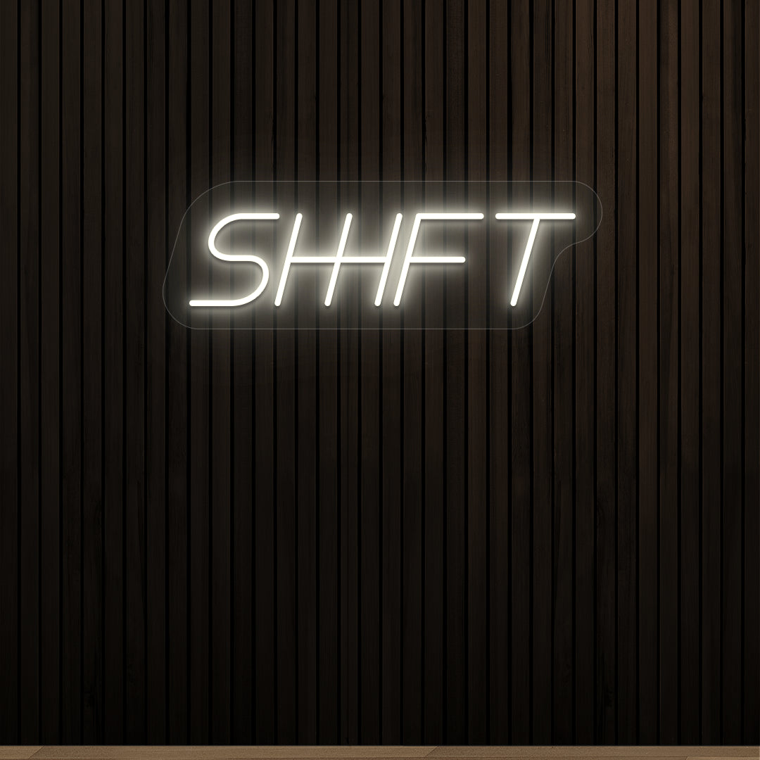 warm white shift vintage neon sign mounted on a wall