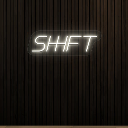 warm white shift vintage neon sign mounted on a wall
