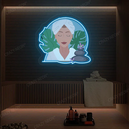 Zen Facial Spa Neon Artwork lighting up in ice blue color on a wooden spa wall