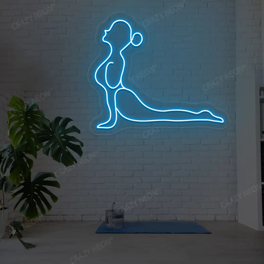 Bhujangasana Yoga Neon Sign glowing in ice blue color in a yoga room