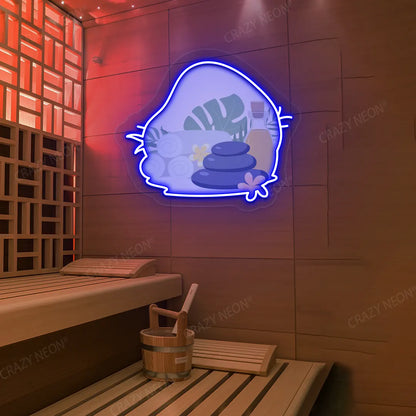 Spa Stones & Serenity Neon Artwork lighting up in blue color on a wooden wall
