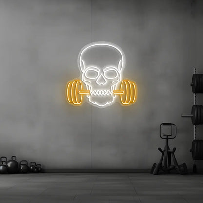 orange and white skull barbell gym neon sign mounted on a wall