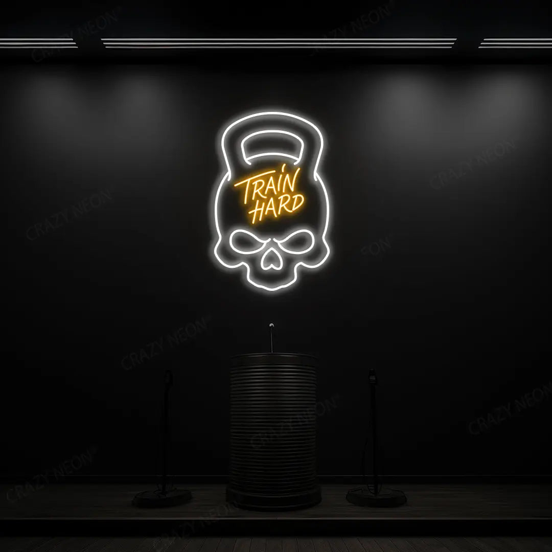 orange and white train hard kettlebell neon sign mounted on a wall