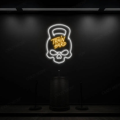orange and white train hard kettlebell neon sign mounted on a wall
