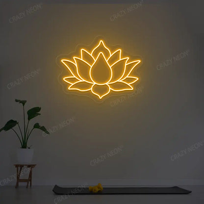 Lotus Flower Neon Sign lighting up in orange color in a yoga room