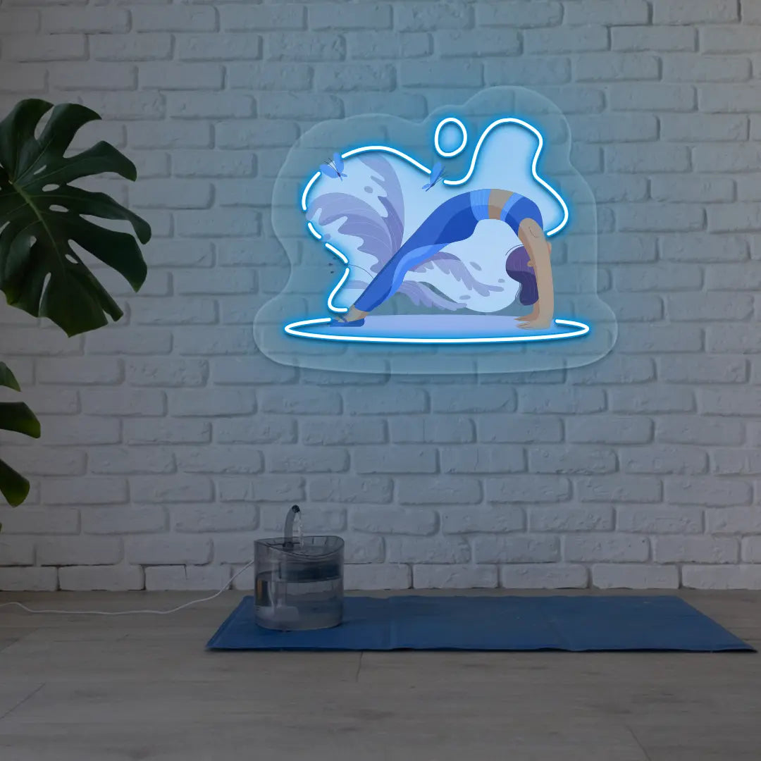 Urdhva Dhanurasana Yoga Neon Artwork lighting up in iceblue color in a yoga room