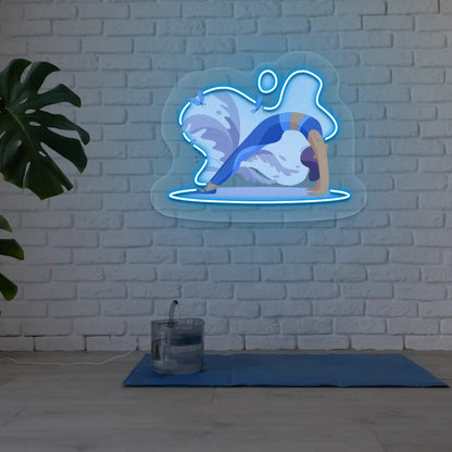 Urdhva Dhanurasana Yoga Neon Artwork lighting up in iceblue color in a yoga room