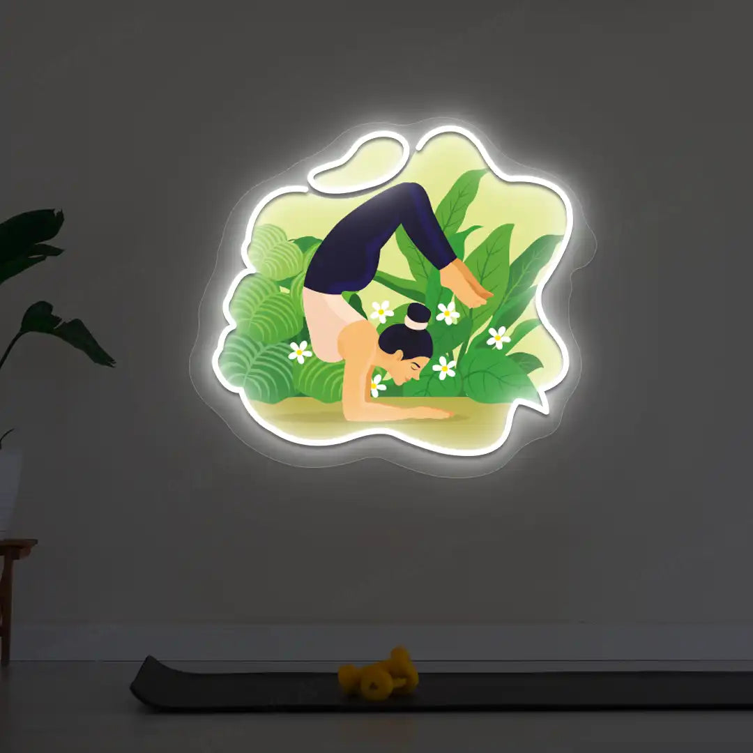 Vrischikasana Garden Yoga Neon Artwork lighting up in white color in a yoga room