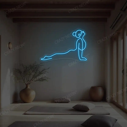 Urdhva Mukha Svanasana Yoga Neon Sign lighting up in ice blue color in a yoga room