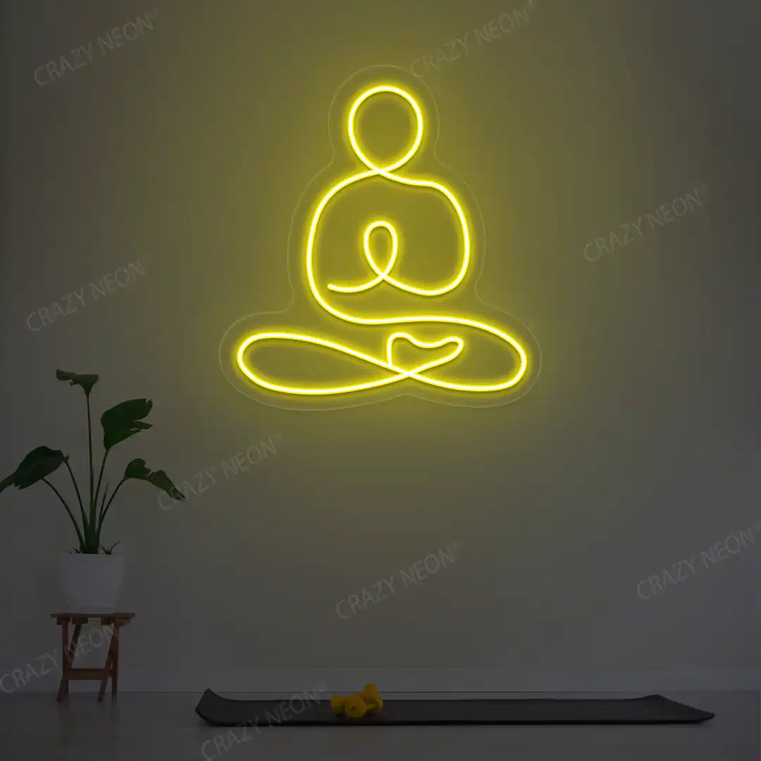Swastikasana Yoga Neon Sign lighting up in yellow color in a yoga room