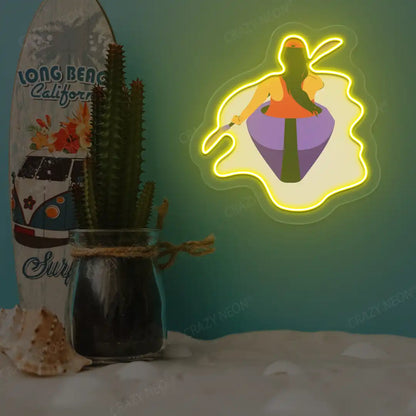 yellow woman kayaking neon artwork mounted on a wall