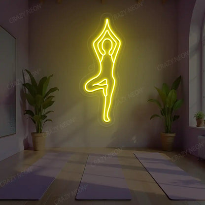 Vrikshasana Yoga Neon Sign lighting up in yellow color in a yoga room