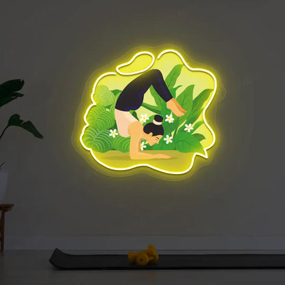 Vrischikasana Garden Yoga Neon Artwork lighting up in yellow color in a yoga room