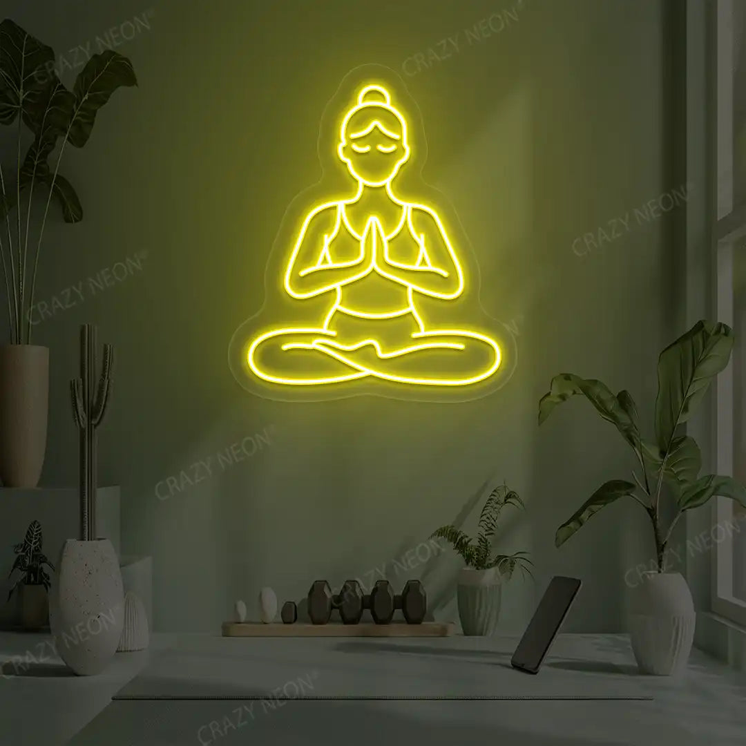 Padmasana Anjali Mudra Yoga Neon Sign lighting up in yellow color in a yoga room