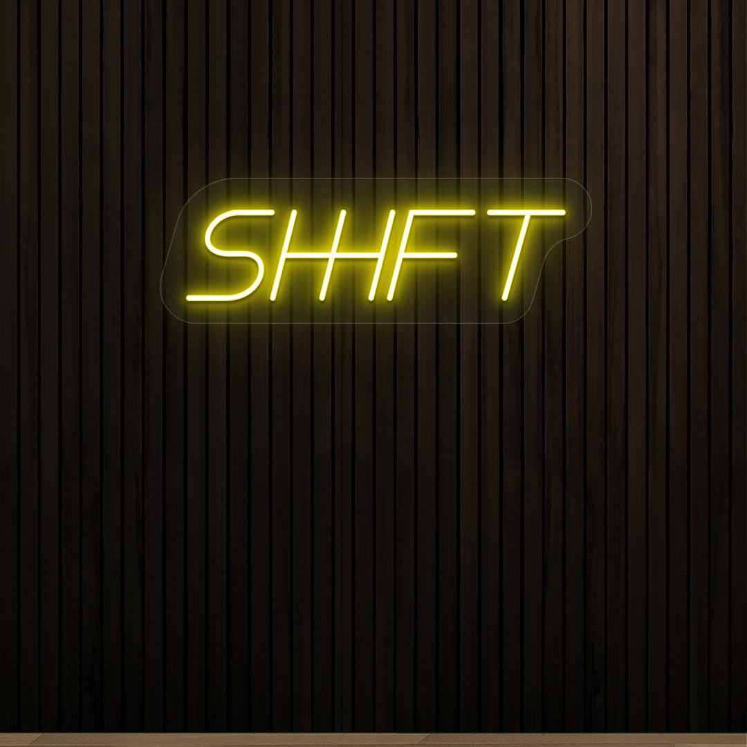 yellow shift vintage neon sign mounted on a wall