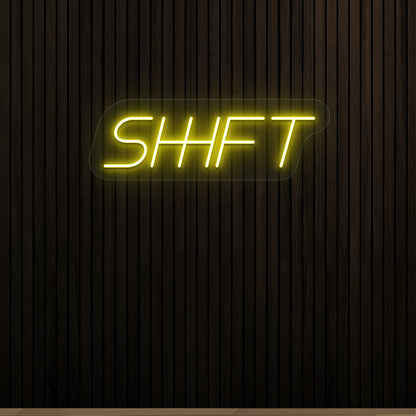 yellow shift vintage neon sign mounted on a wall