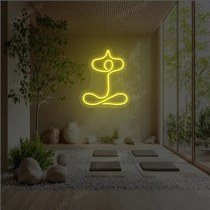 Sukhasana With Arms Raised Contour Yoga Neon Sign glowing in yellow color in a yoga room