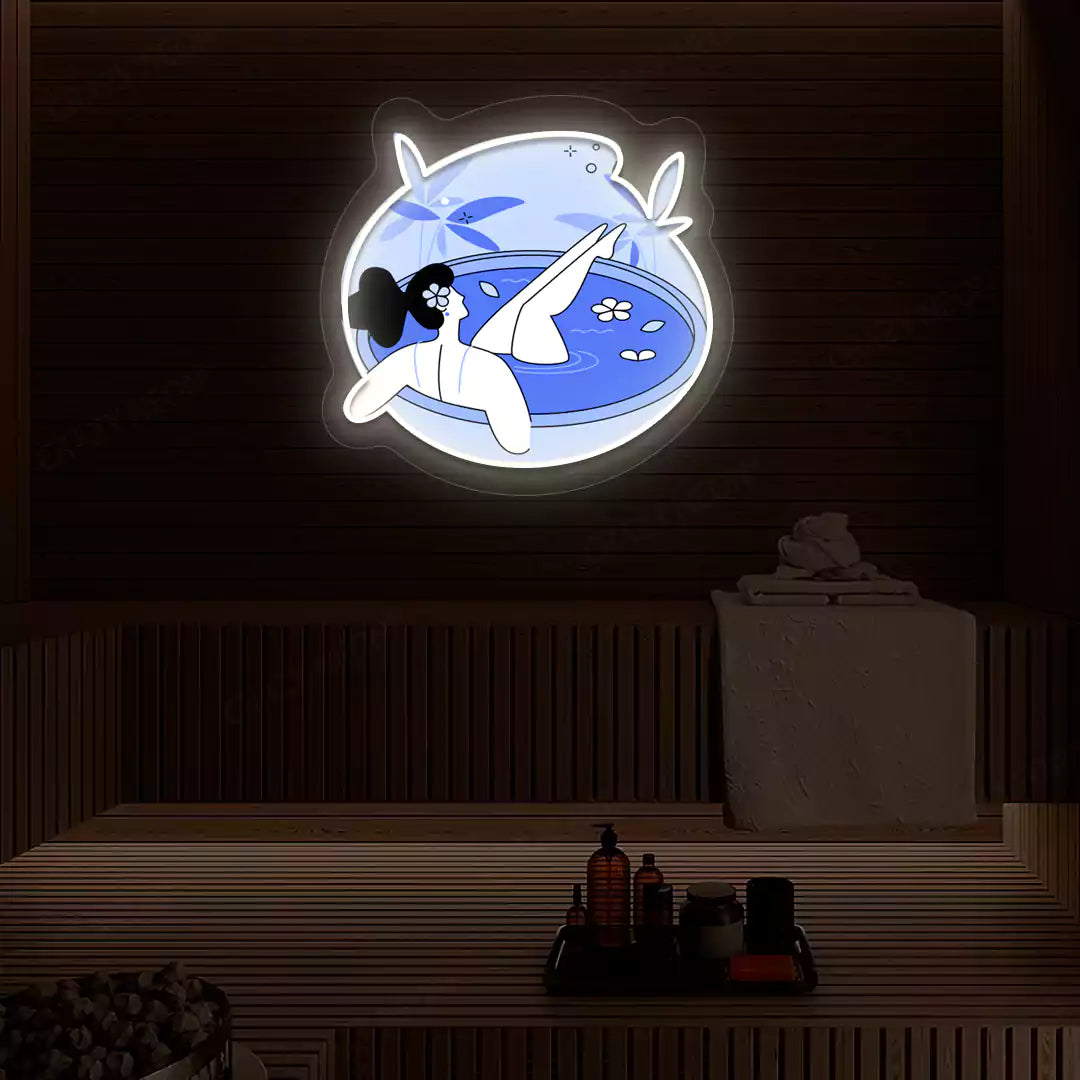 Blue Blossom Bath Neon Artwork lighting up in warm white color on a wooden spa wall