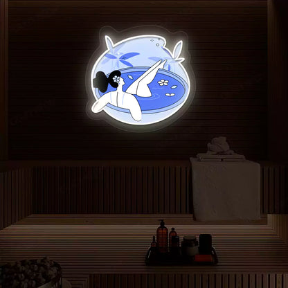 Blue Blossom Bath Neon Artwork lighting up in warm white color on a wooden spa wall