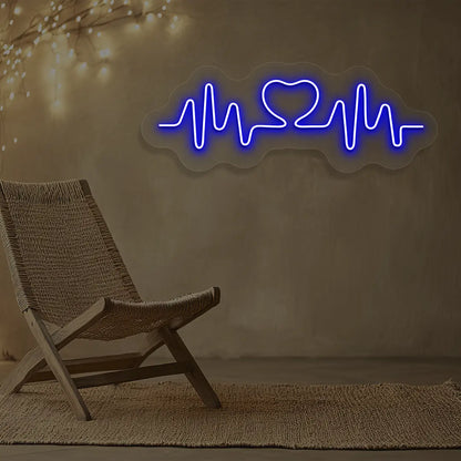 blue love pulse neon sign mounted on a wall