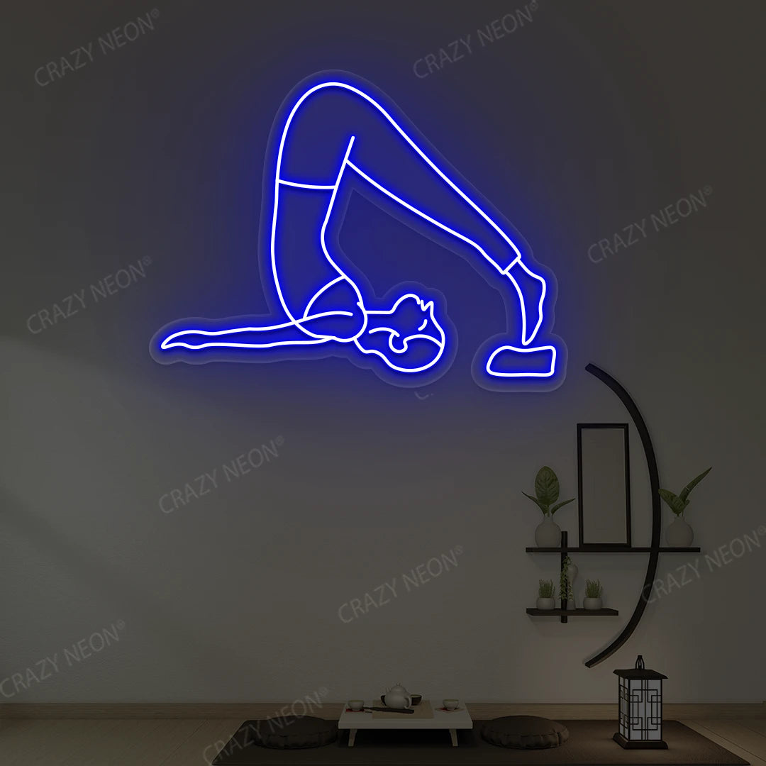 Halasana Yoga Neon Sign glowing in blue color in a yoga room