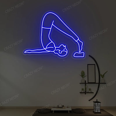Halasana Yoga Neon Sign glowing in blue color in a yoga room