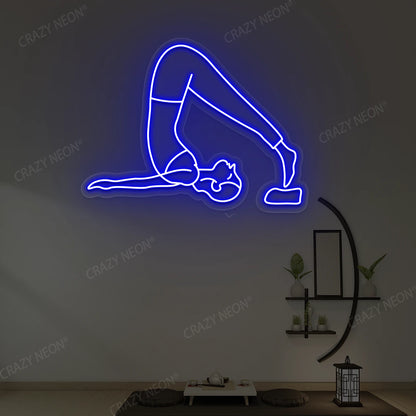 Halasana Yoga Neon Sign glowing in blue color in a yoga room