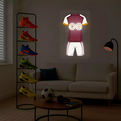 Maroon football jersey neon artwork with number 08 glowing on a beige wall