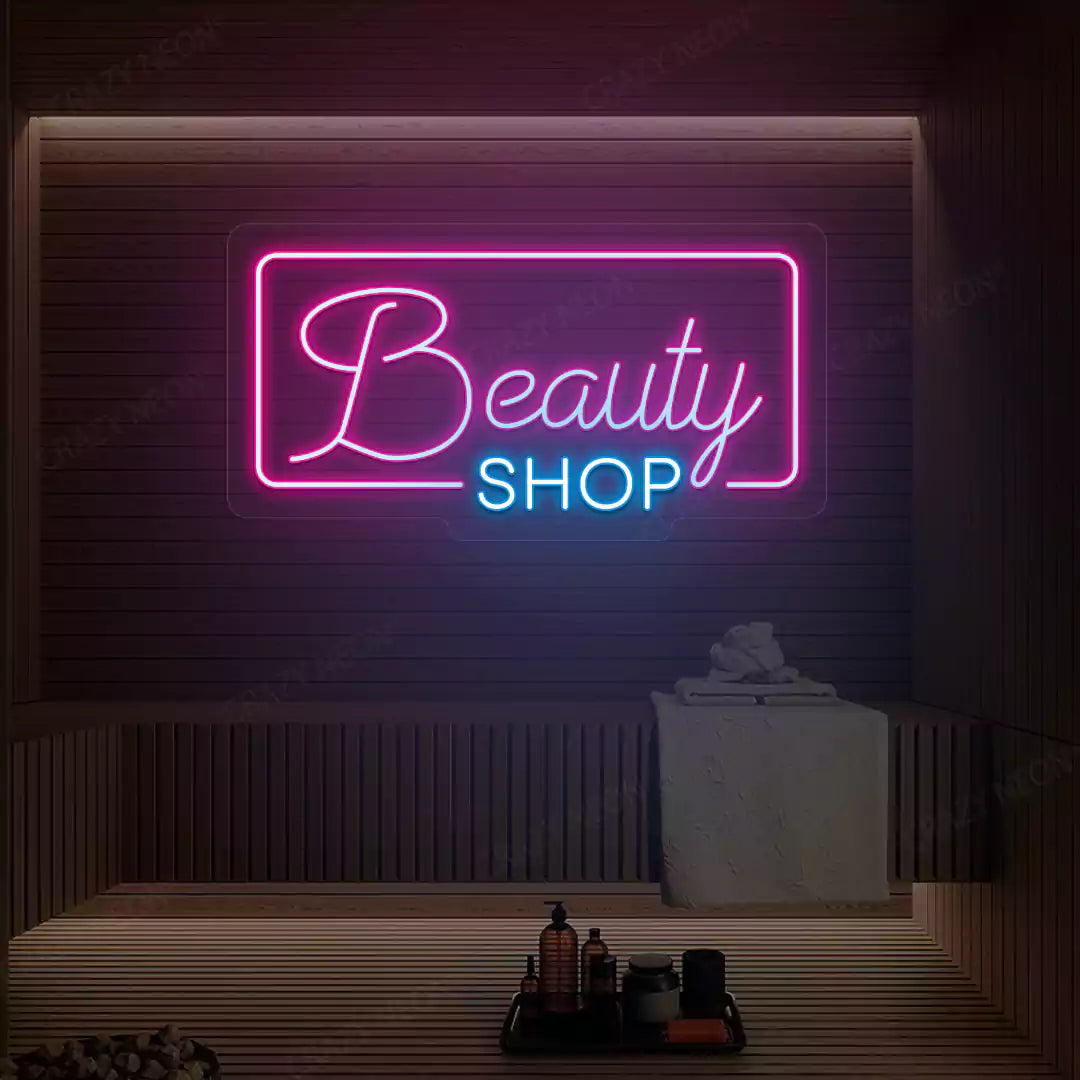 Pink and ice blue Beauty Shop neon sign glowing on a wooden wall
