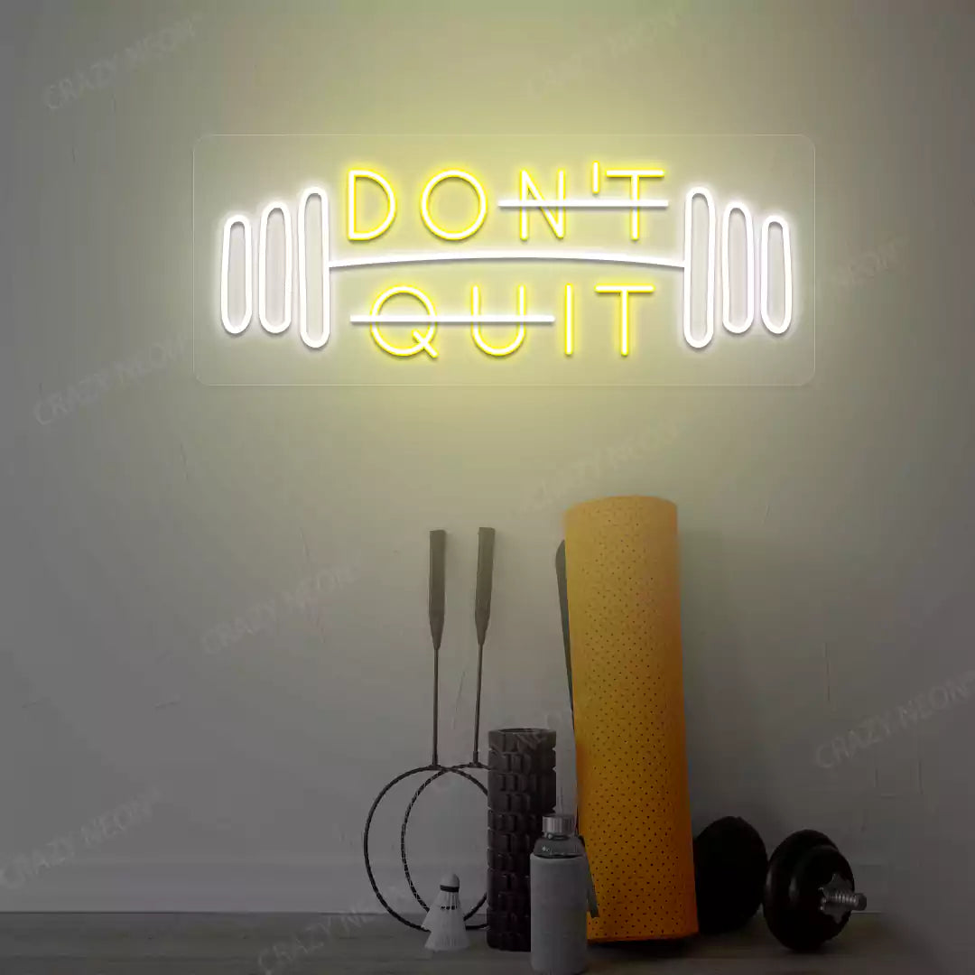 yellow and white don’t quit do it neon sign mounted on a wall