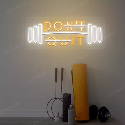 orange and white don’t quit do it neon sign mounted on a wall
