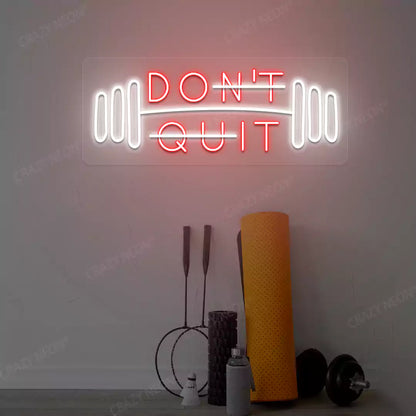 red and white don’t quit do it neon sign mounted on a wall