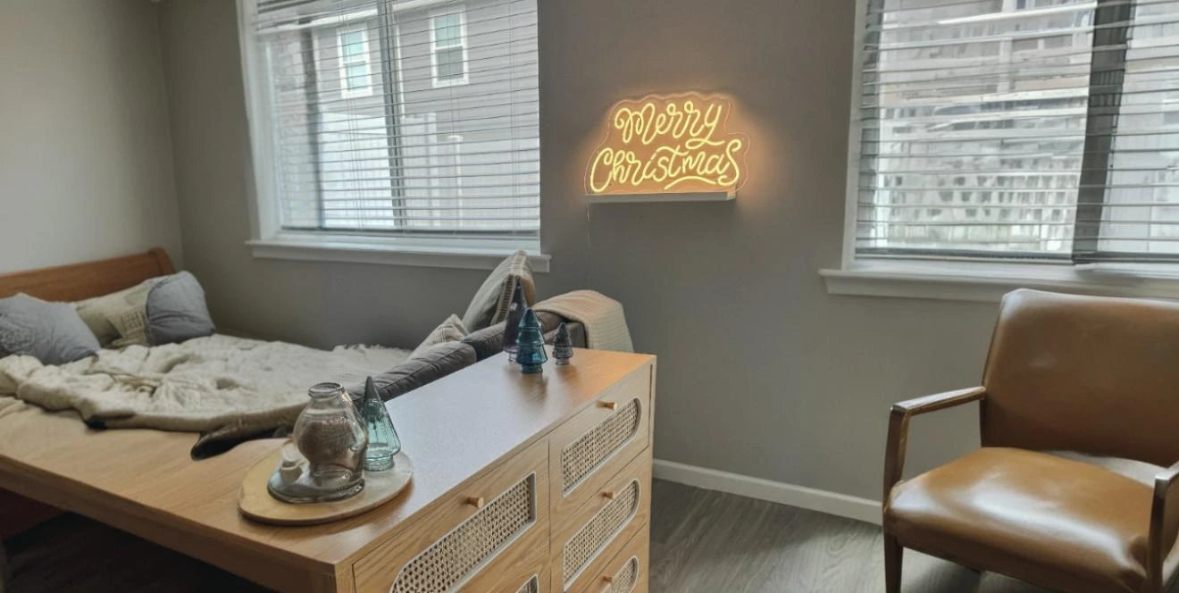 Minimalist bedroom with Merry Christmas neon sign on grey wall