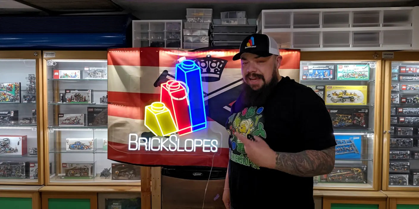 Man with beard in store in front of BrickSlopes multicolor LED neon artwork sign