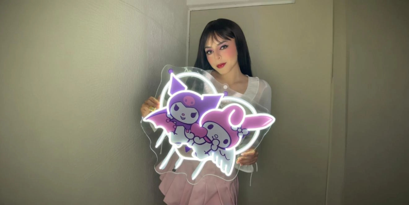 Woman in white top and pink skirt holding glowing My Melody and Kuromi with kawaii heart LED neon artwork