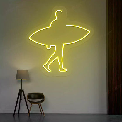 yellow man surfer neon sign mounted on a wall