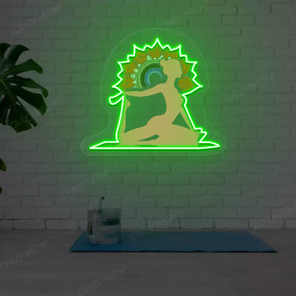 One-Legged King Pigeon Pose Mandala Yoga Neon Artwork lighting up in green color in a yoga room