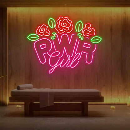 Pink PWR Girl Floral neon sign glowing on a wooden wall