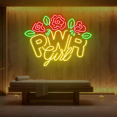 Yellow PWR Girl Floral neon sign glowing on a wooden wall