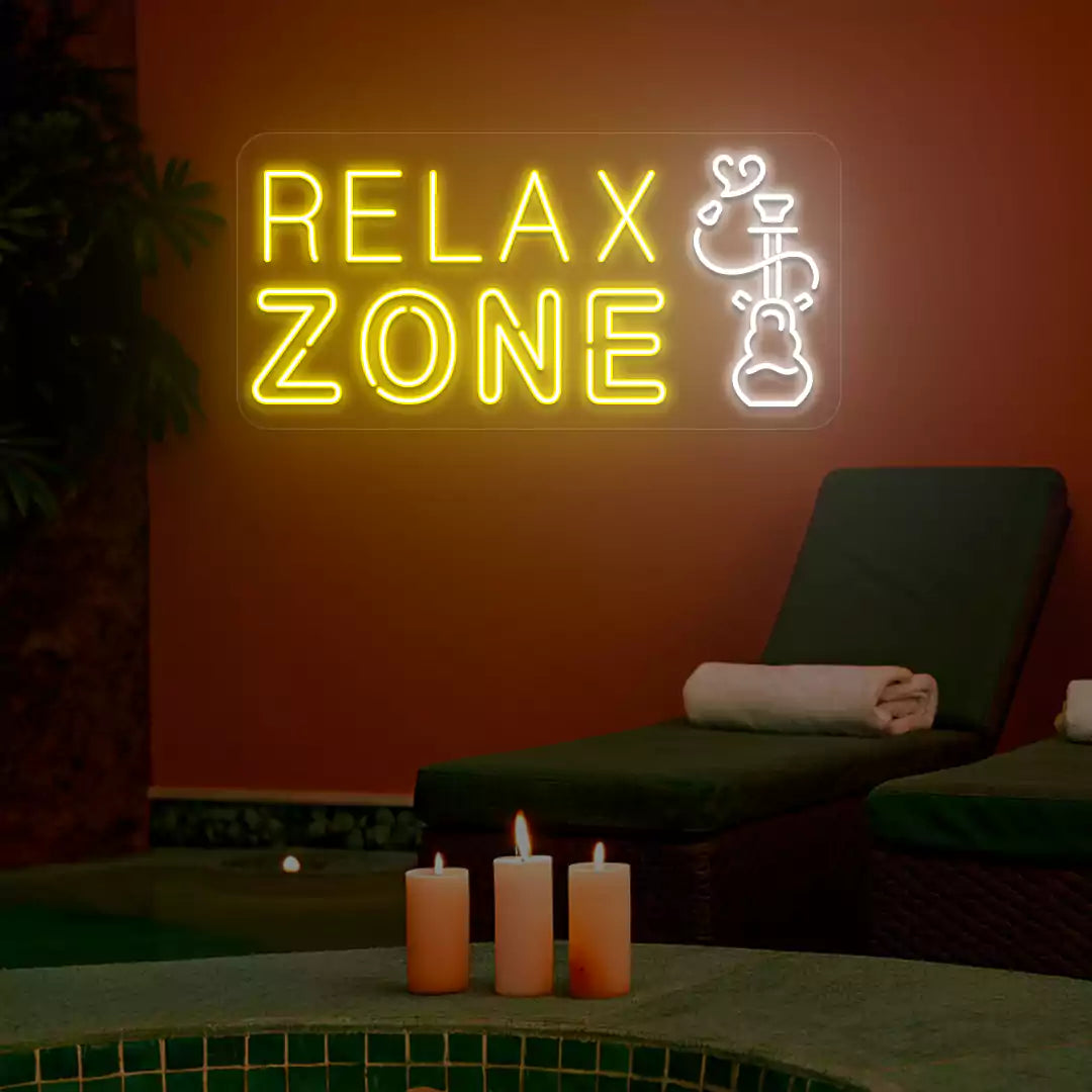 Yellow and white Relax Zone neon sign glowing on a wall
